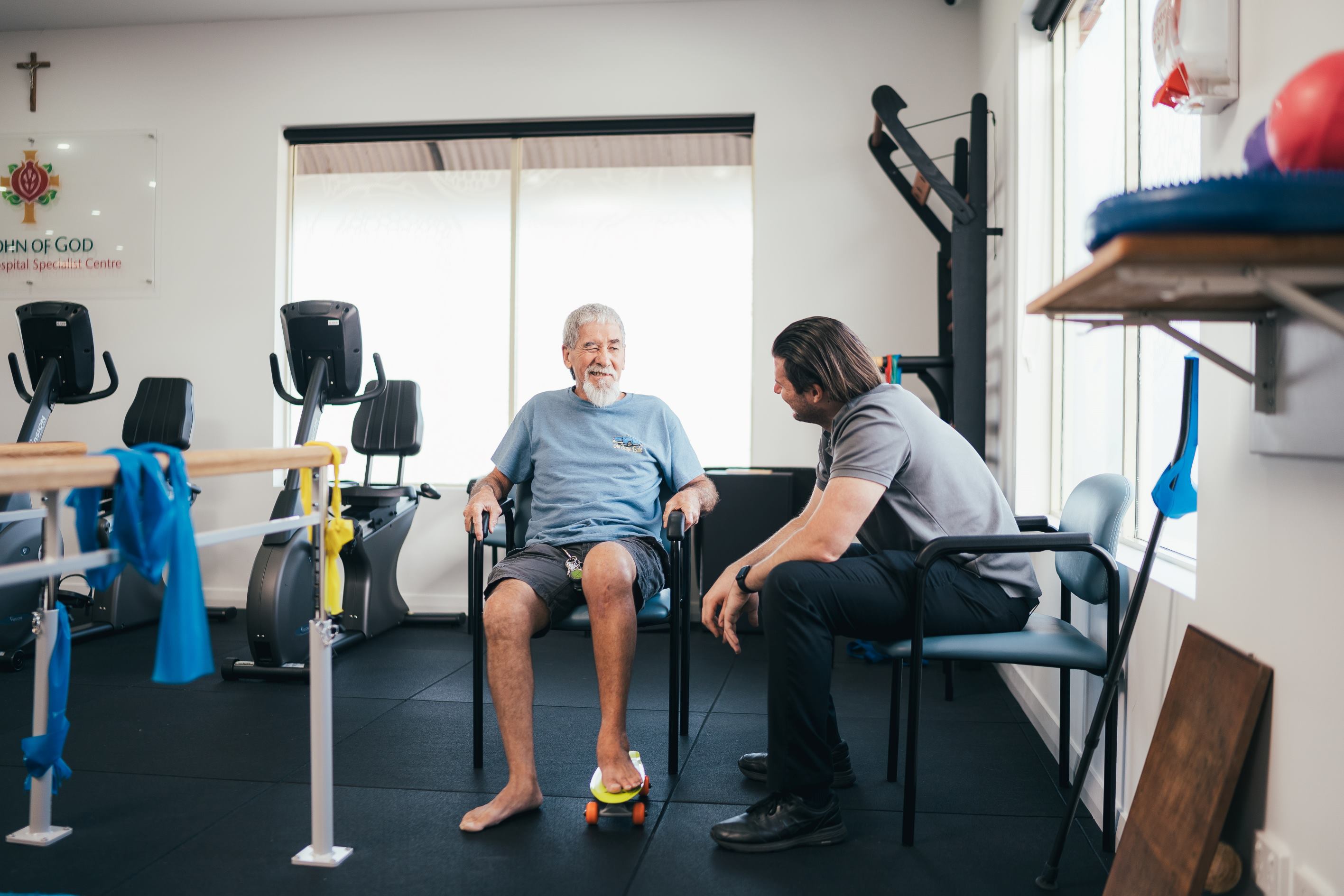 Caregiver working with patient in rehab