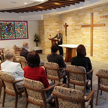 area of new chapel with a ceremony happening with caregivers sat