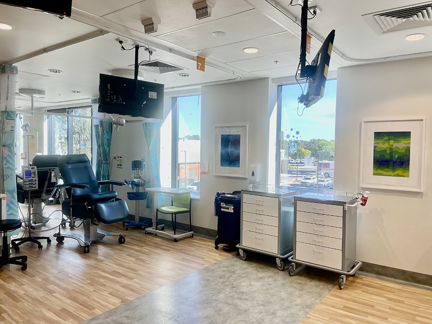 A treatment room with artworks hanging on the walls.