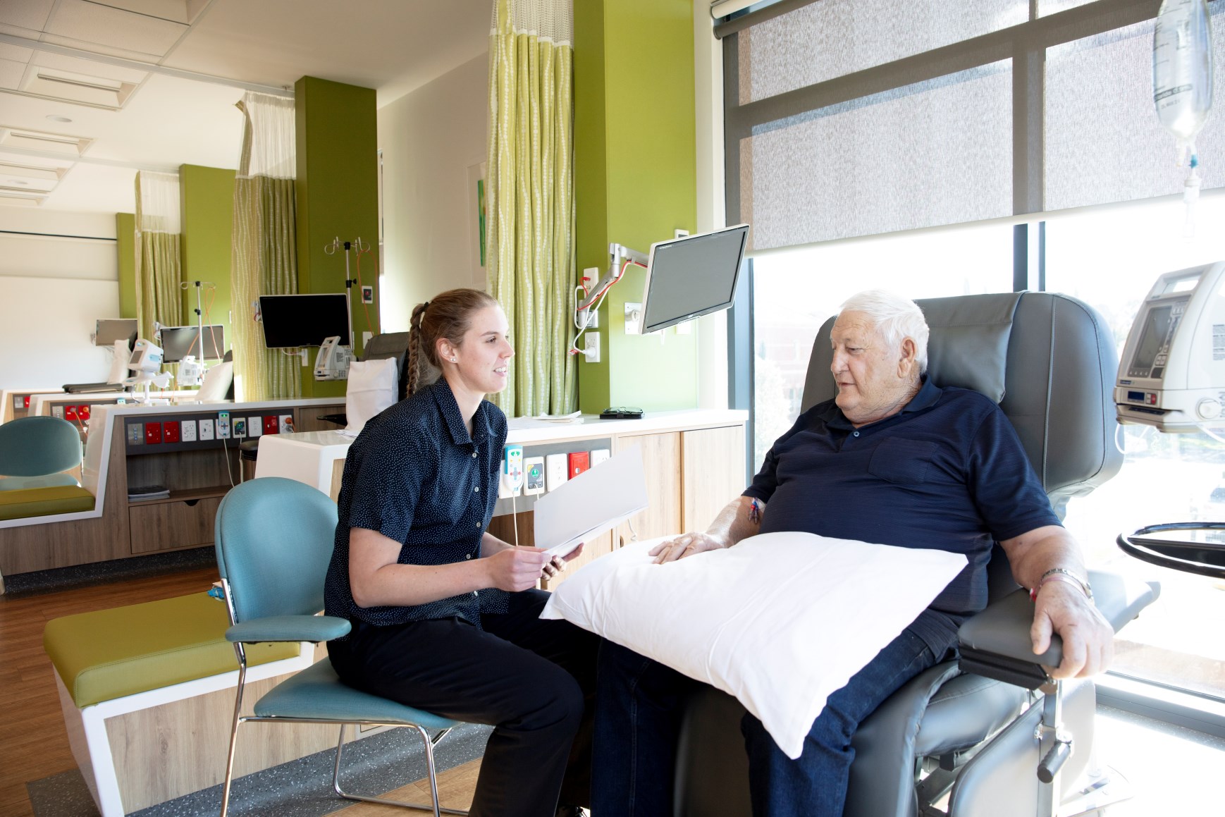 Caregiver taking notes while talking with patient