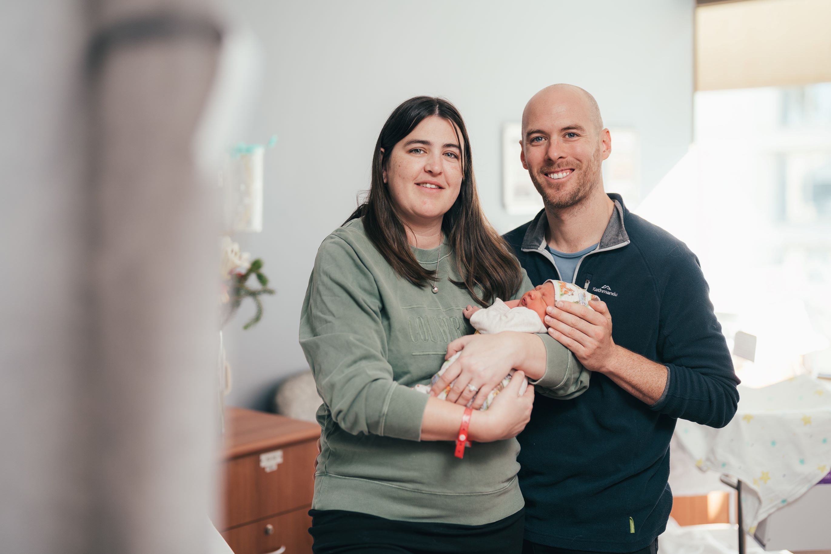 Parents holding their newborn baby