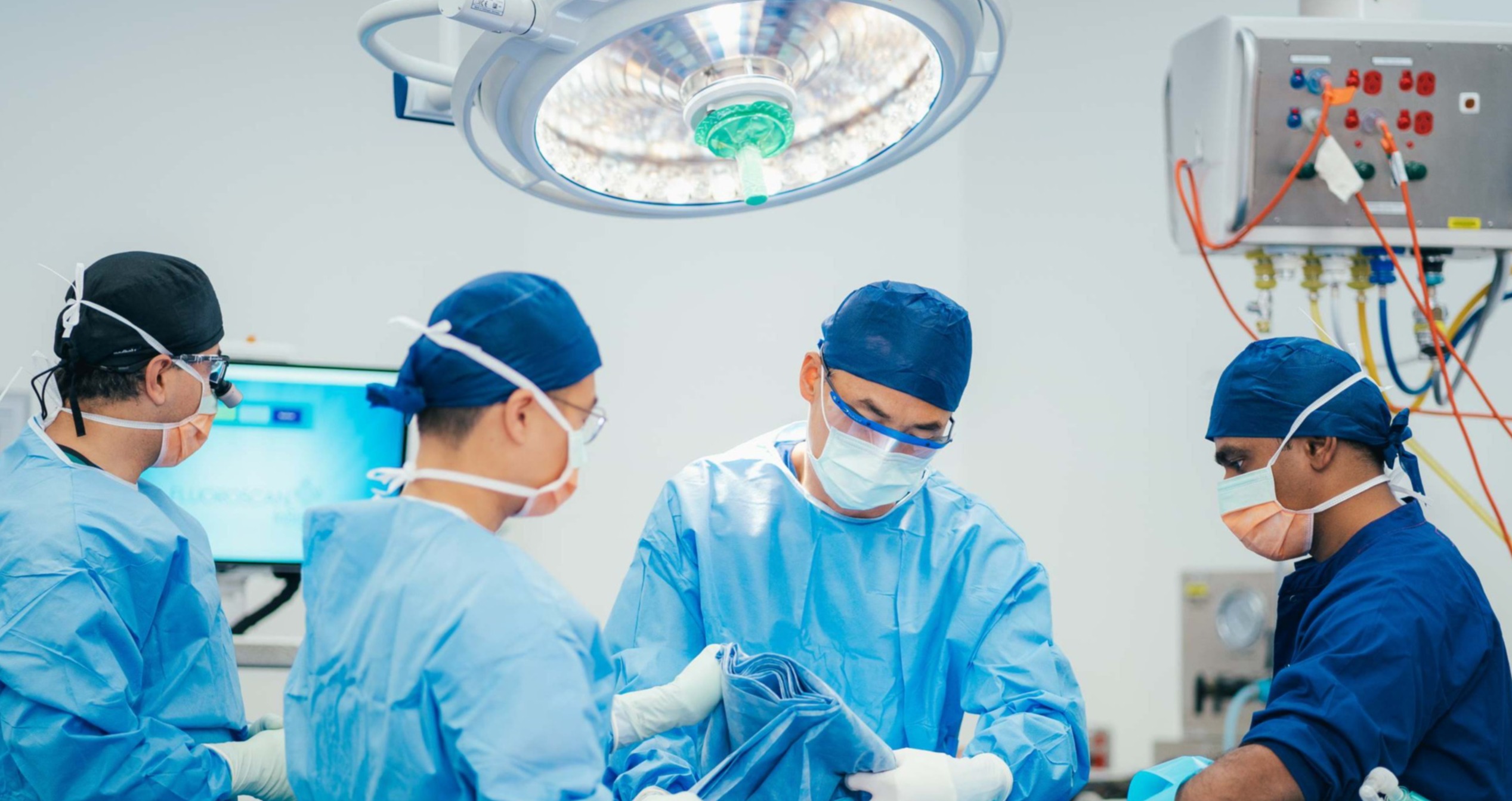 Doctors and caregivers performing surgery in operating room