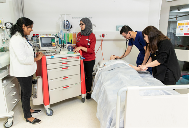doctors around patient in bed 