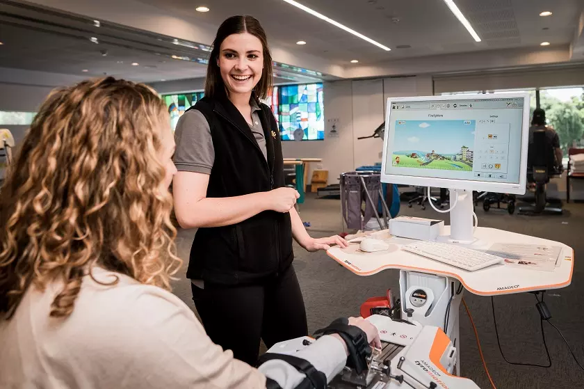 patient on therapy machine with nurse