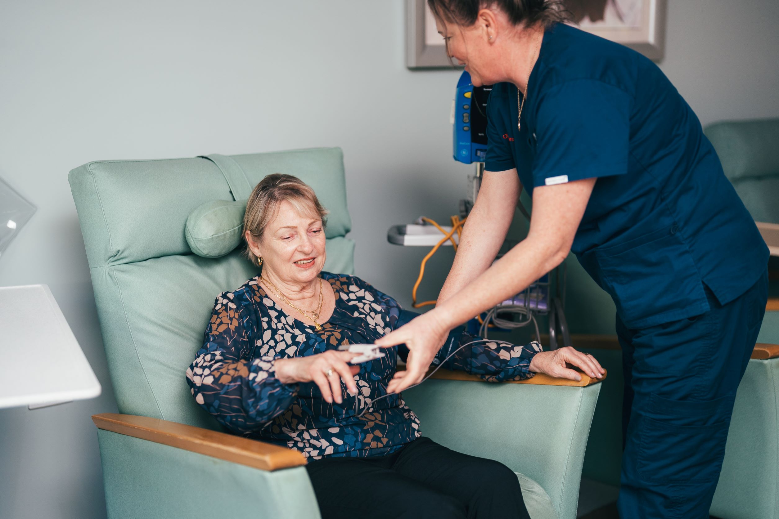 caregiver measuring patients vitals 