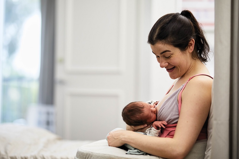 Woman breastfeeding newborn baby in hospital