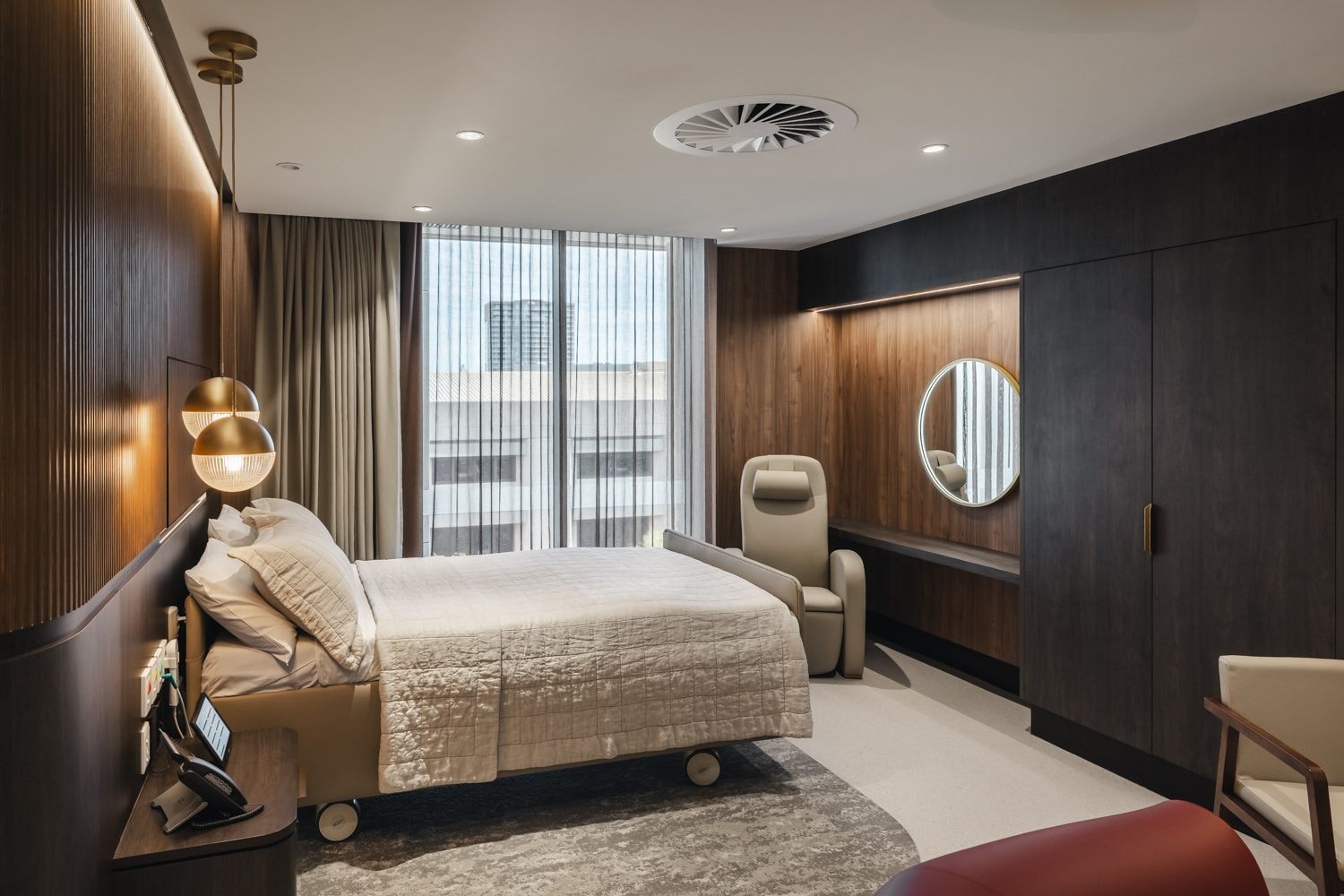 The bed, cupboard and window in The Suites
