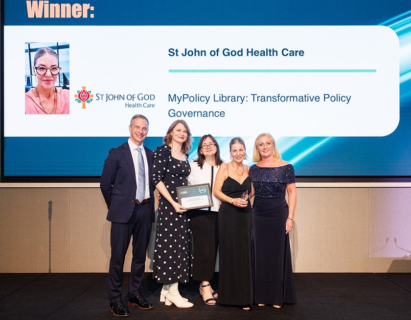 The MyPolicy Library project team smile for a photo holding the award