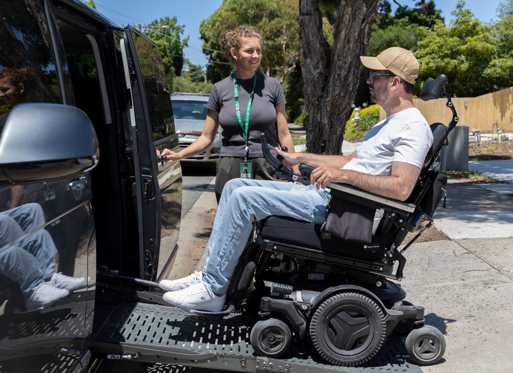 Resident and social worker on ramp entering Van with a wheelchair
