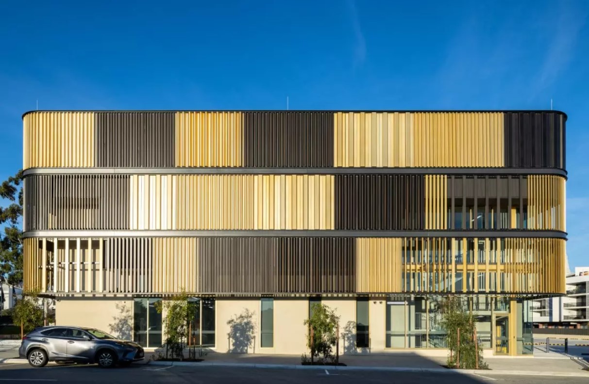 Render of the Site Energy Plant, a modern, yellow building