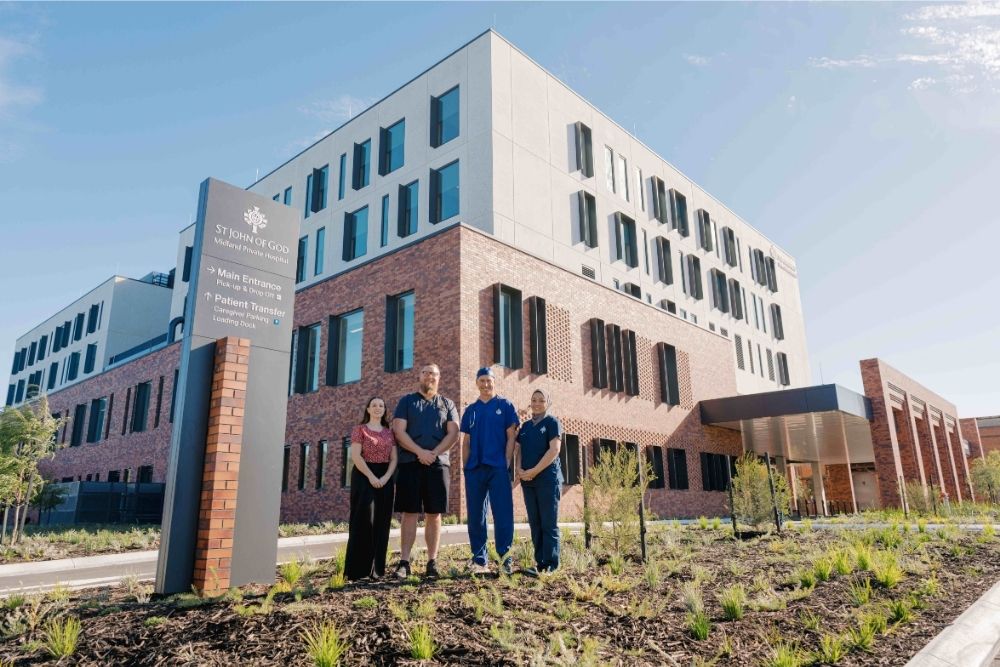 Four caregivers standing in front of the new St John of God Midland Private Hospital