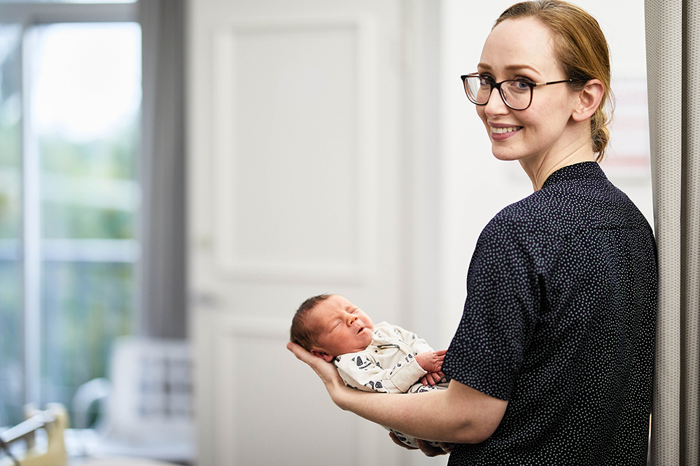 Midwife holds newborn baby