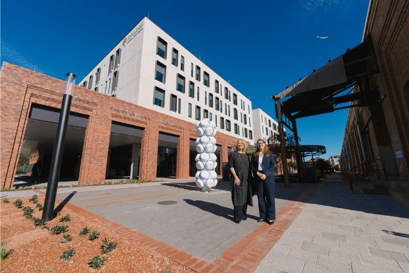 Donna Marcus, the artist behind Clasp, with St John of God Midland Private Hospital Chief Executive Officer, Vanessa Unwin standing outside with the sculpture.
